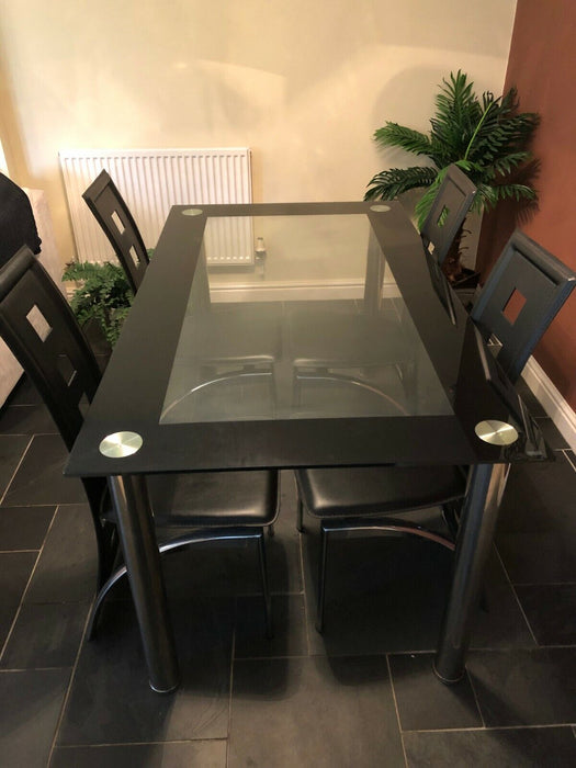 Black glass dining table and four chairs