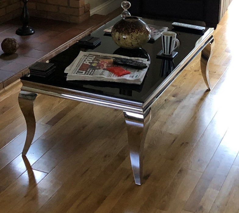 Coffee Table Chrome legs and base with black tempered glass top.