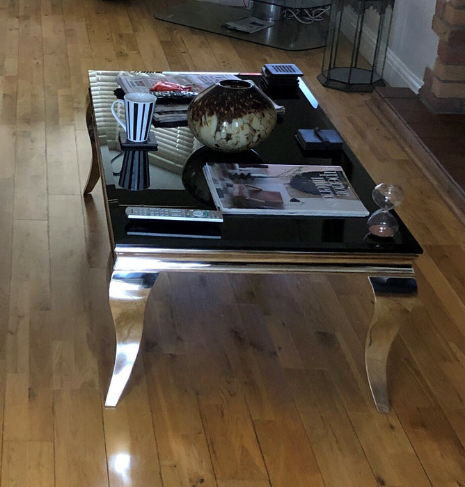 Coffee Table Chrome legs and base with black tempered glass top.