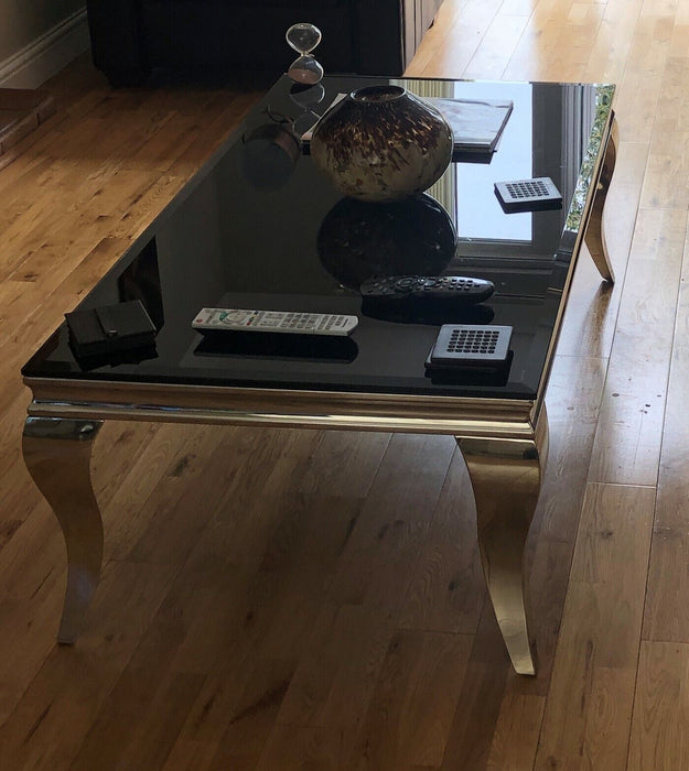 Coffee Table Chrome legs and base with black tempered glass top.